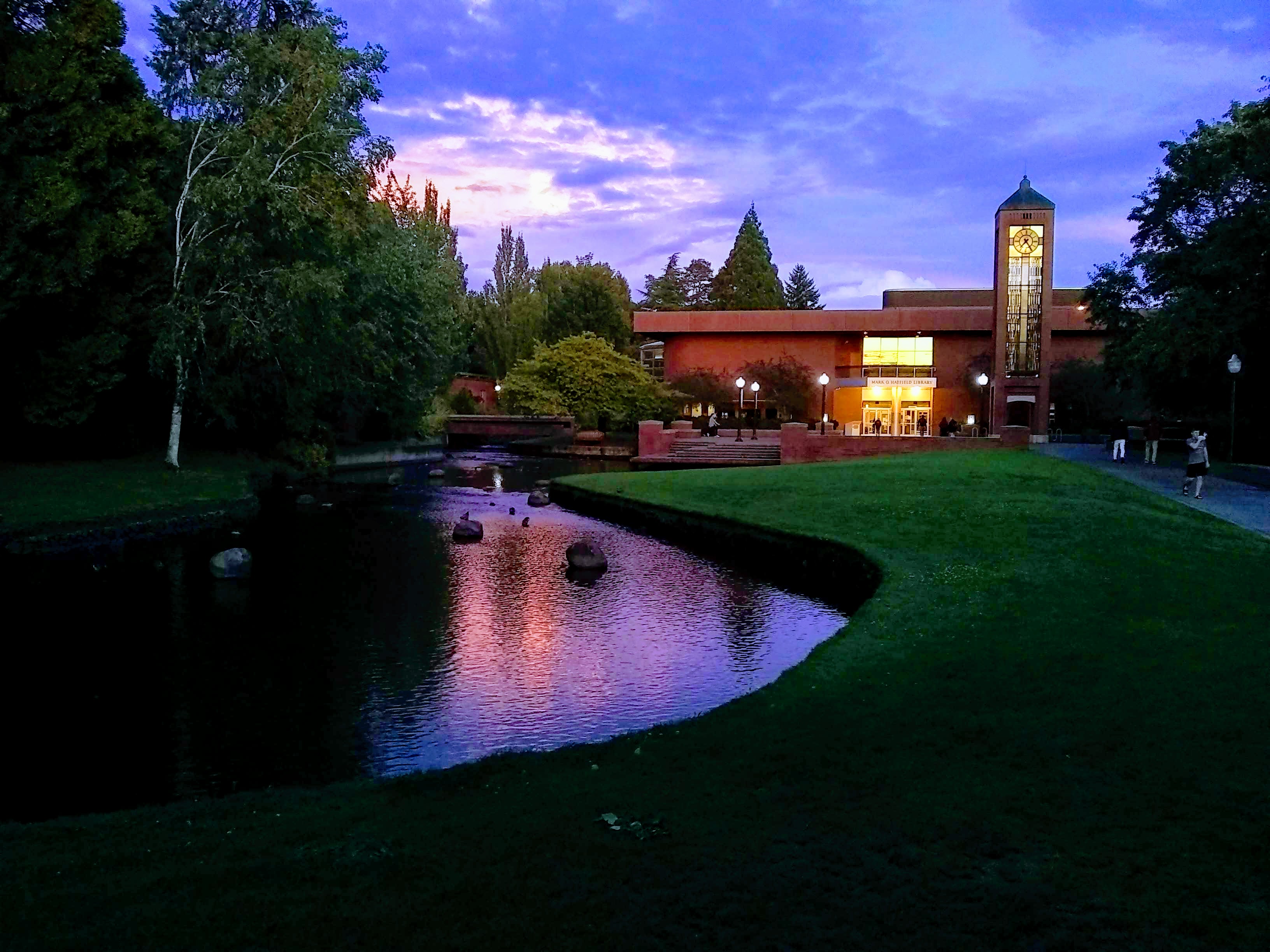 Jackson Plaza, the Hatfield Library, and the Mill Stream at sunset