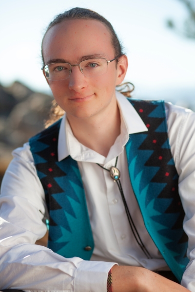 Juni looks dashing in a white shirt and colorful, Western-style vest